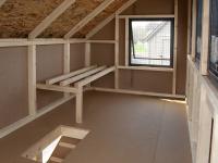 Interior of 6x8 Chicken Condo Style Chicken Coop with Roosts, nesting boxes, windows, and ramp to lower run