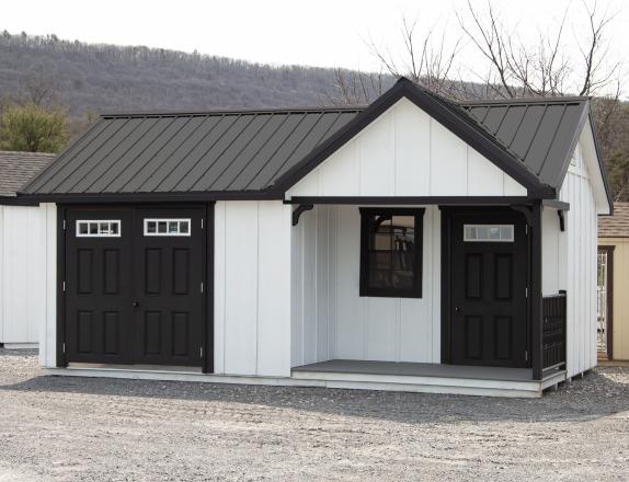 Custom 12x20 Victorian Building with Porch and with White LP Board N Batten Siding, Black Doors, Black Trim, and Black Metal Roof